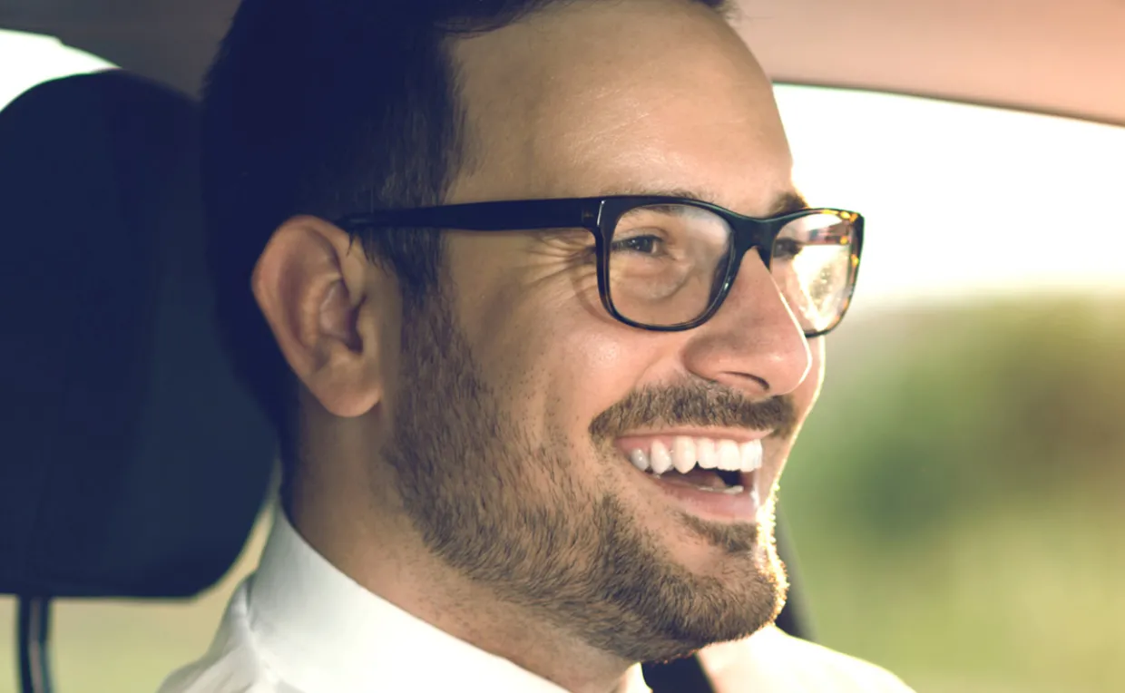 Man Driving in Car with Glasses